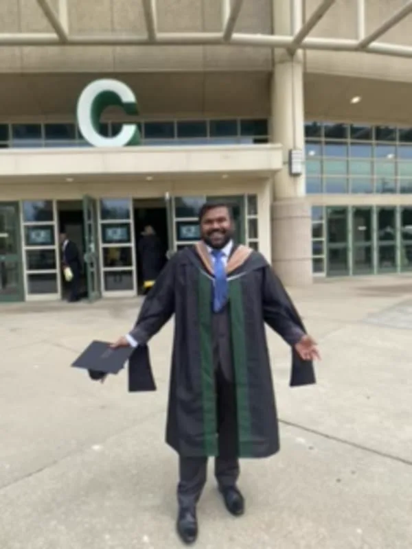 Sai Srinivas celebrating his master's graduation outside Cleveland State University